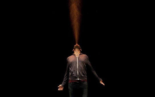 Actor on stage blowing steam from his mouth