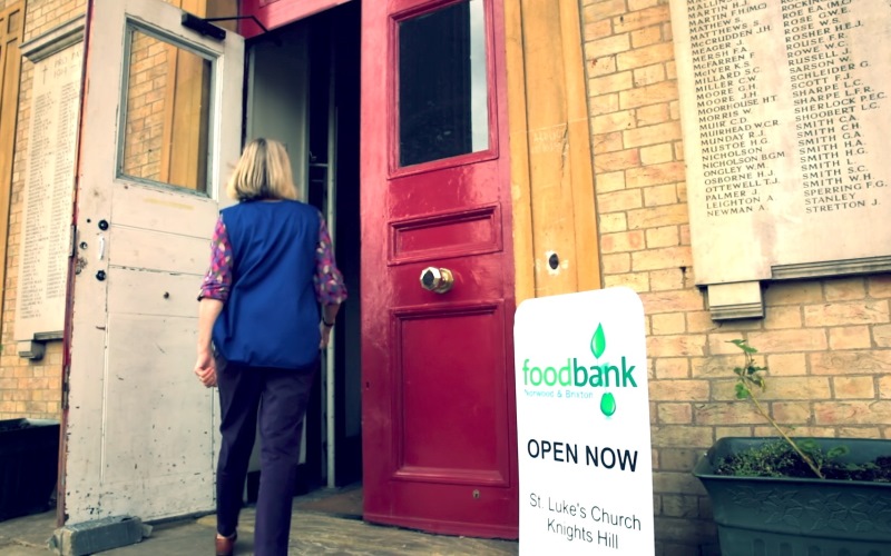 person walking in to a foodbank
