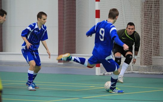 Futsal players on an indoor pitch