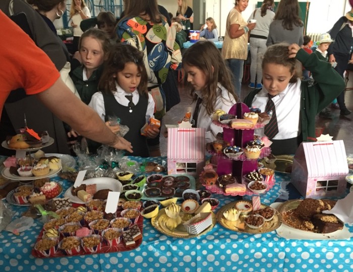 Mad Hatters tea party cake sale table hungry customers