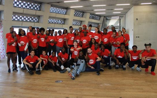 Members of The Movement Factory are shown gathered together as a group in their red coloured t-shirts prior to the lockdown.