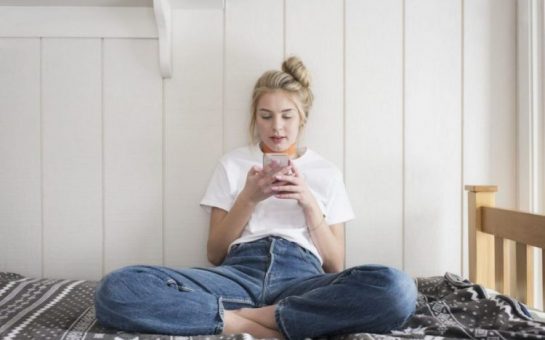 A young girl checking out her dating matches on her phone