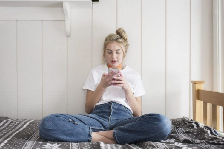 A young girl checking out her dating matches on her phone
