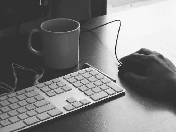 keyboard mouse and coffee at office desk