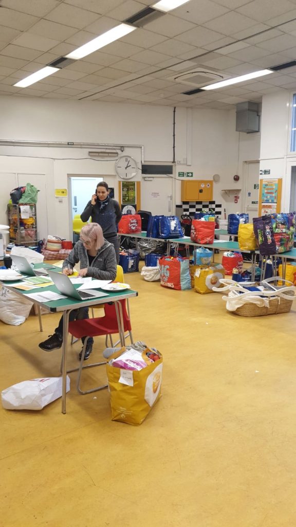 Little Village team members organise emergency packages for delivery