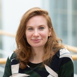 Eleanor Ratcliffe has shoulder length auburn hair looking at the camera