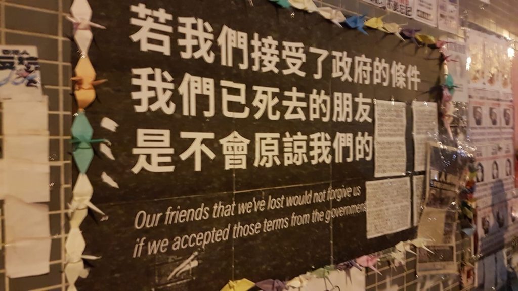 A sign saying: "Our friends that we've lost would not forgive us if we accepted those terms from the government."
