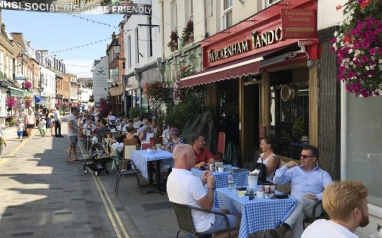 Lots of happy customers eating outside of restaurants in the sunshine in Twickenham because of the Eat Out to Help Out scheme.