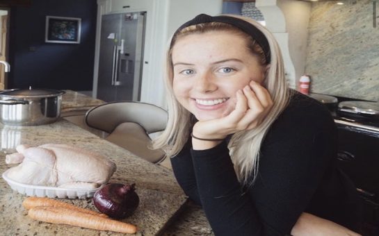 Sophie Richards with a chicken, onion and carrots ready to cook