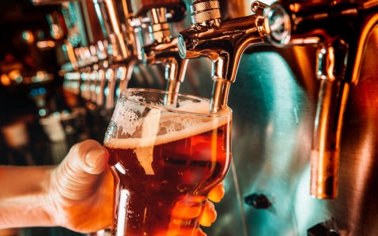bartender pours a pint