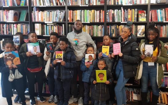 Darrel Blake with kids from Black Rooted Academy at New Beacon Books