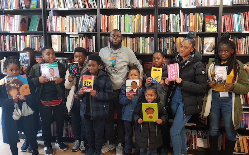 Darrel Blake with kids from Black Rooted Academy at New Beacon Books