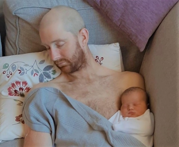 Baby Rosa peacefully sleeping in her father's arms.