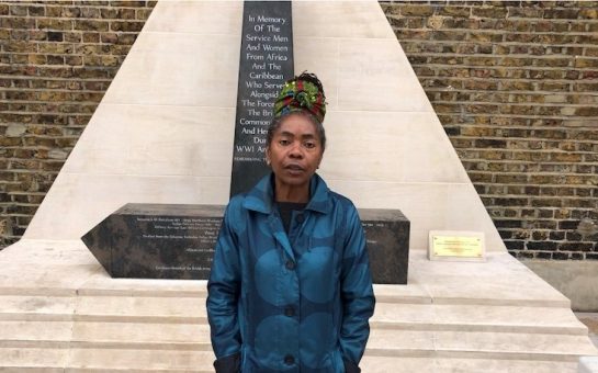Councillor Sonia Winifred standing by memorial statue