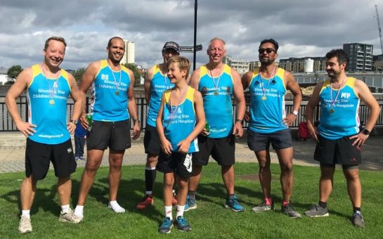 Ironsides runners stand together with medals after finishing the marathon