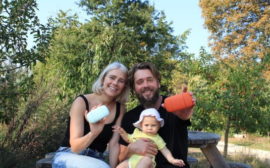 Woman man and baby on bench holding natural deodorant