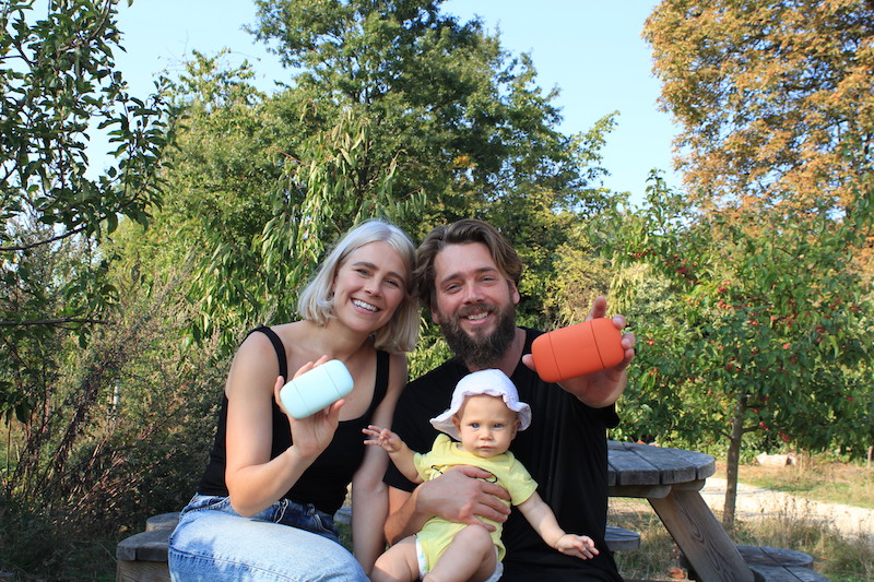 Woman man and baby on bench holding natural deodorant