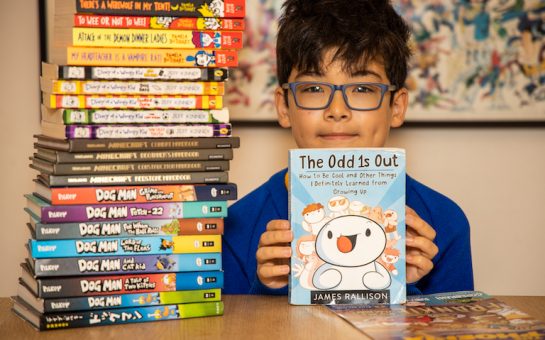 £5 million in library fines across London as 10-year-old Nicholas Hampartsoumian with a selection of books