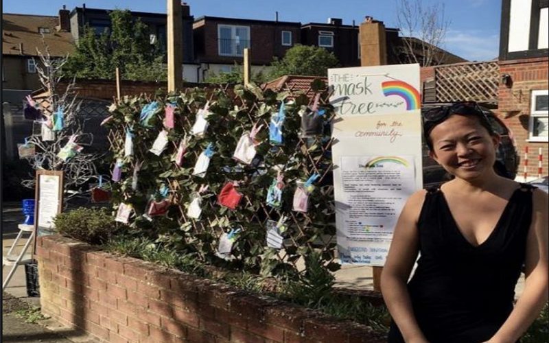 Syebvonne Nguyen outside her home in Morden in front of 'tree' with masks hanging in bags to collect
