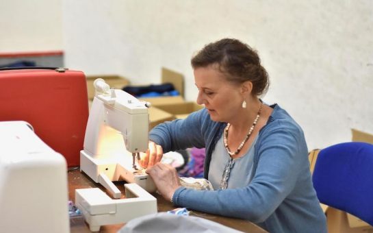 Rosie Taylor-Davies, founder of The Scrubbery, making NHS scrubs using a sowing machine