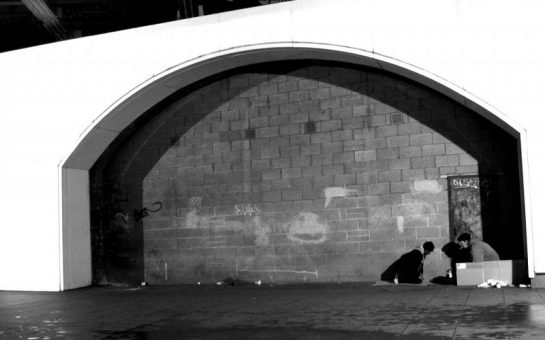 A homeless person against a backdrop