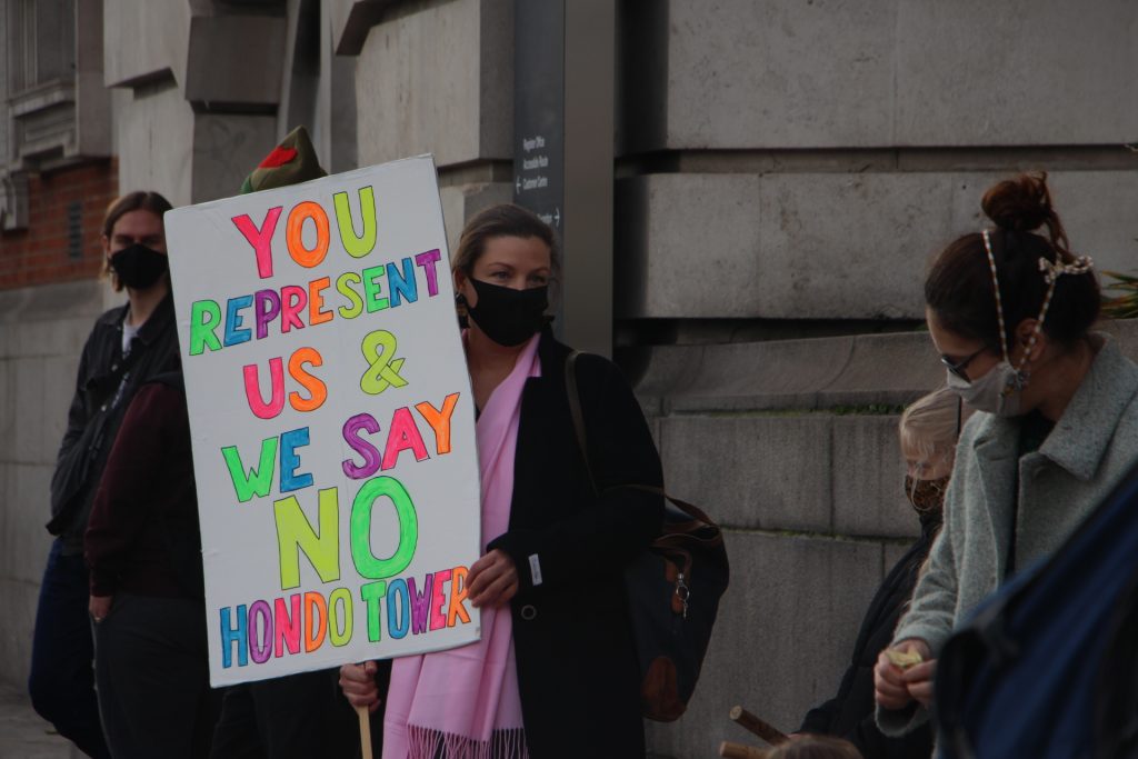 A protestor holds a sign in opposition to the proposed tower in Brixton