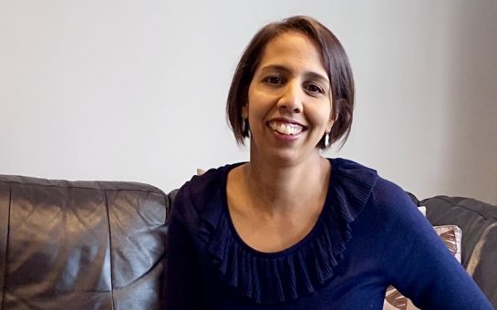 Munira Wilson MP sitting on couch