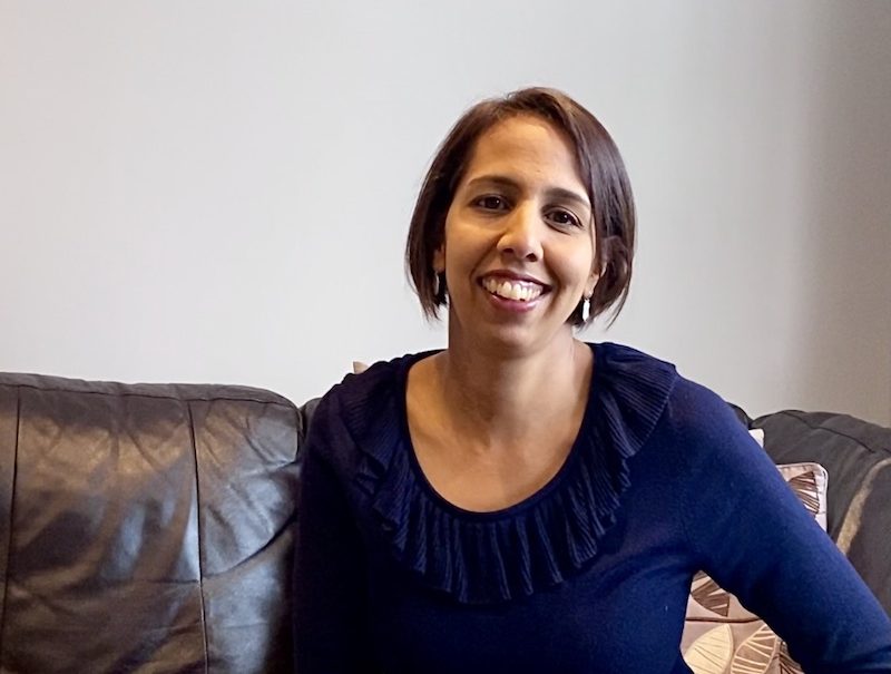 Munira Wilson MP sitting on couch
