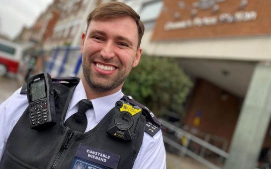 Police officer smiles at camera