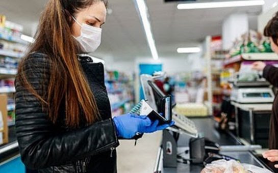 person stands at the checkout in a supermarket