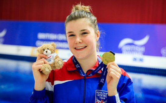 Andrea Spendolini-Sirieix holding a teddy and a medal.