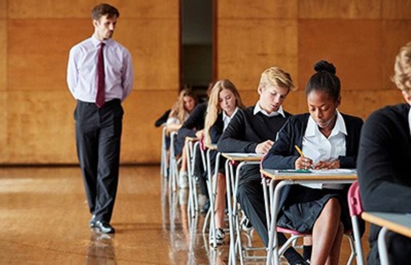 teacher with pupils sitting exams