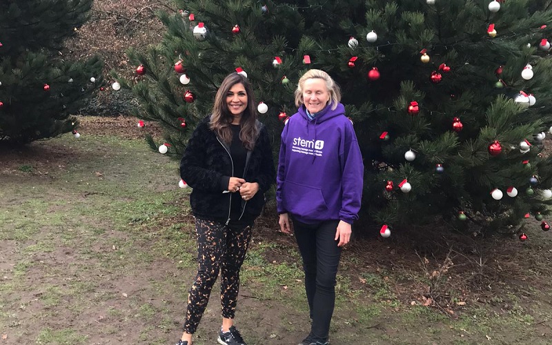 Dr Nihara Krause and Ali Love in front of one of the wishing trees