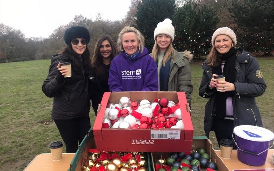 volunteers pictured with baubles in front of trees in Wimbledon Common