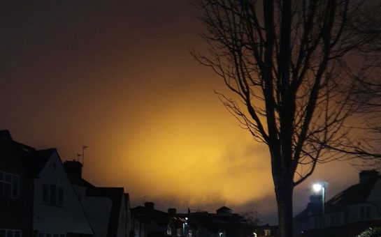 orange glow in sky over houses in Twickenham