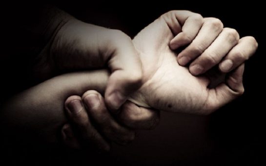 domestic violence picture of one hand grabbing an arm
