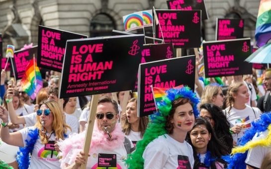 Image of LGBTQ campaigners on the streets in London with placards