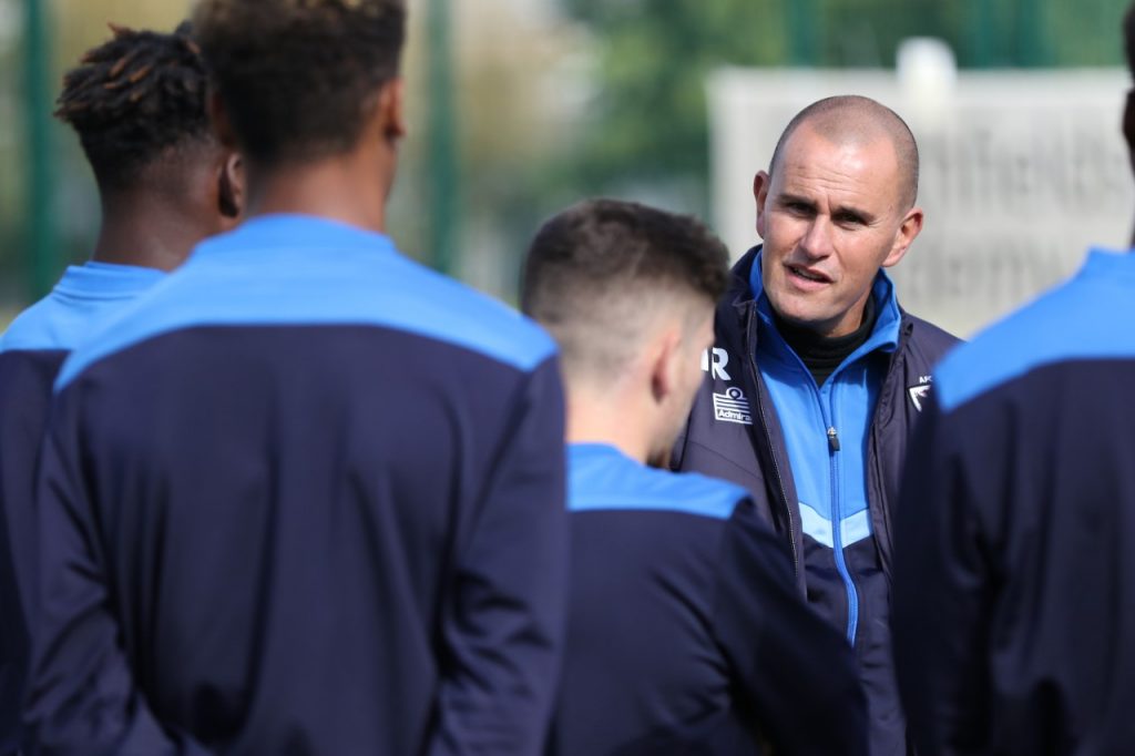 AFC Wimbledon interim manager Mark Robinson talks to his players