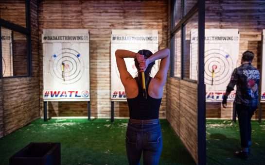 woman lining up to throw an axe at the target
