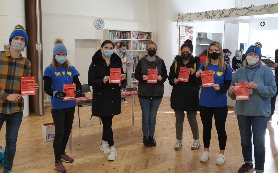 AFC Wimbledon fan volunteers with COVID test leaflefts