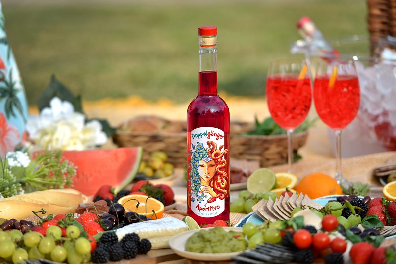Doghouse Distillery aperetif spirit product shot with food on picnic planket
