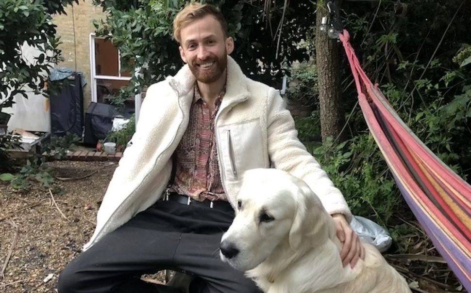 'Bees and Refugees' charity founder Ali Alzein sits with his white labrador in garden