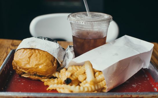 a burger with fries and a coke