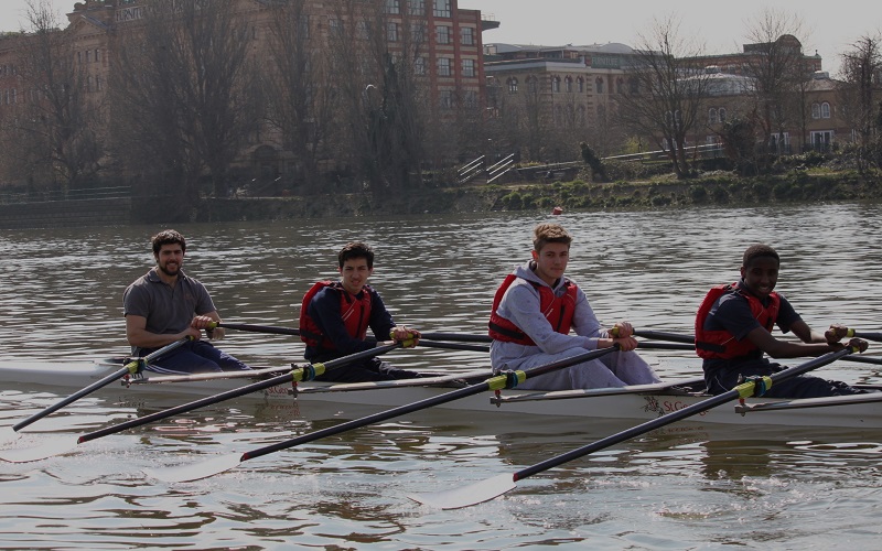 Students rowing on the river via Fulham Reach Boat Club.