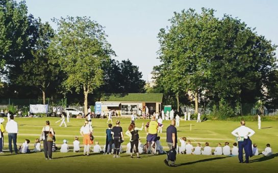 A junior team playing cricket in Acton