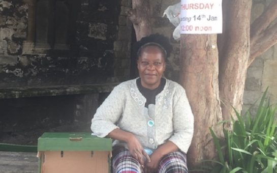 woman smiling with food bank donation