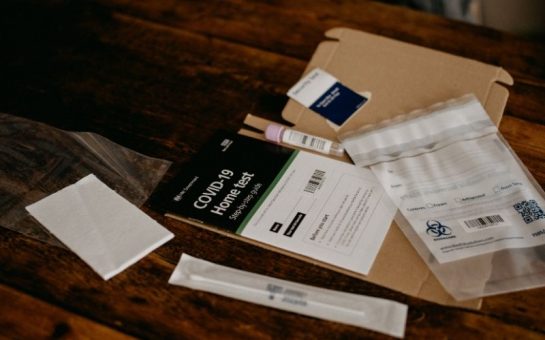 The contents of a home Covid-19 test are spread over a table