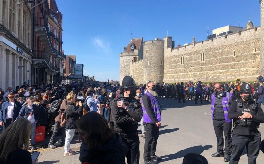 policeman amongst crowd outside windsor for the funeral of prince philip