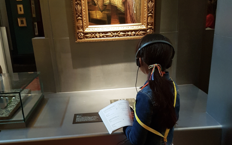 Primary school student looks at Leighton House art during a pre-lockdown workshop