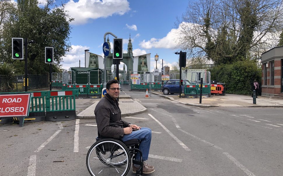 Wheelchair user in front of Hammersmith Bridge